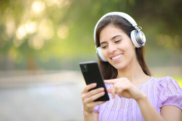 Happy woman listening to music using headphone