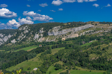 Obraz premium Les Bouchoux, France - 09 02 2021: View of the landscapes of Les Bouchoux with the village, hills, forests and The promontory .