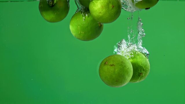 Limes fall under water with bubbles. Filmed on a high-speed camera at 1000 fps. High quality FullHD footage