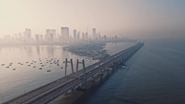 Cinematic Aerial view of vehicles Passing over Bandra Worli Sea Link in Mumbai, India. Weather in Mumbai, Morning skyline Mumbai. Developing India concept. Longest Bridge in India.
