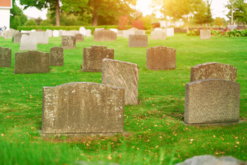 Graveyard on a sunny day. Cemetery graveyard white and grey tombstones.