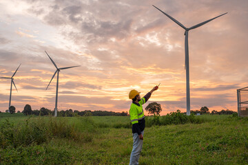 Engineer wearing uniform inspection and survey work in wind turbine farms rotation to generate...