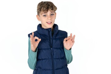 Caucasian teen boy wearing blue vest over white background  showing both hands with fingers in OK...