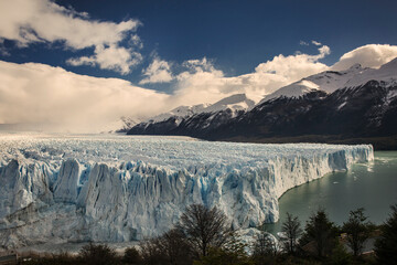Panoramic view of Perito Moreno and Lake Argentino surrounded by the snow-capped Patagonian Mountains 
