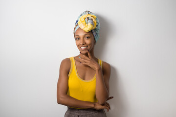 Portrait of beautiful happy young casual black woman wearing a headwrap. - 673754406
