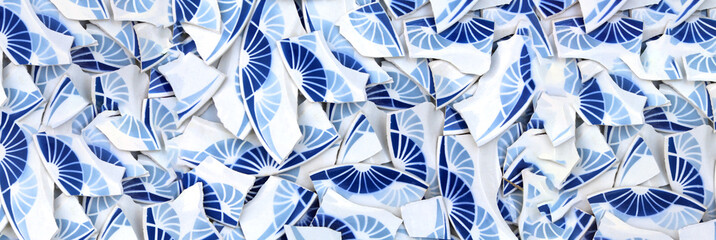 Background of broken plates with blue decorations