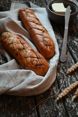 white bread on a towel on a wooden table, rustic style