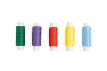 Colorful spools of thread on a white background