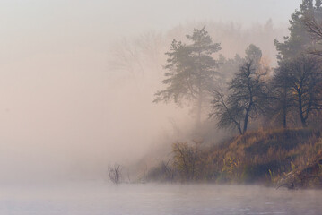 Obraz na płótnie Canvas foggy sunrise over the river