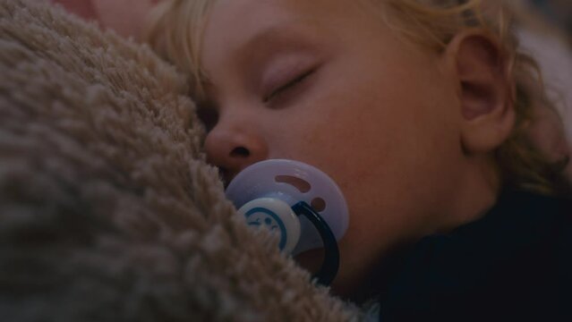 Close up of toddler sleeping with a pacifier. Shot with RED helium camera in 8K.  