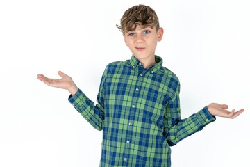Careless attractive  Caucasian teen boy wearing plaid shirt shrugging shoulders, oops.