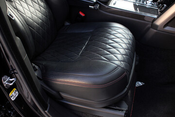 Black leather passenger seats. Interior of prestige car. Comfortable perforated leather seats....