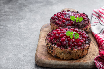Tasty homemade cranberry tarts on gray background