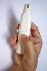 Woman's right hand holding dog electric nail file on white background, Electric manicure and pedicure, Accessories for manicure, Dog, Cat, Animal care in beauty salon concept, Close up shot