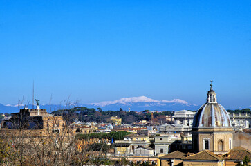 rome's cityscape with  snowy mountains