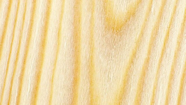 Wood, processed wooden yellow board, tree structure background, rotating, turning, close-up macro, top view
