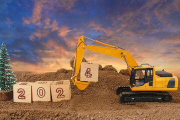 Concept Happy new year 2024,crawler excavator in construction site .on sunrise backgrounds