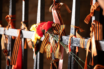 Many St. George ribbons are tied to the black metal structure as a symbol of the Great Patriotic...