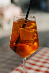 Glass with cocktail on the table in a traditional Italian restaurant.
