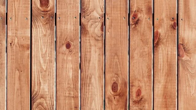 Surface background of wooden boards fastened with screws, moving sideways, close-up
