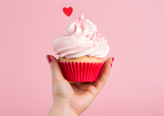 Close up of Girl Hand  with a Cupcake, Topped with a Tiny Heart: A Sweet Gesture of Love and Delight ,  Suitable for Valentine's Day, Mother's Day, and Other Love-Related Occasions