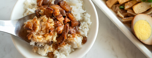 Braised meat over cooked rice, famous and delicious street food in Taiwanese restaurant.
