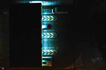 Aerial view of cars entering a gas station. Vehicles parking in underground parking garage.
