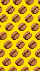 Fresh roasted coffee beans isolated over yellow background. Pattern of coffee. Contemporary art...