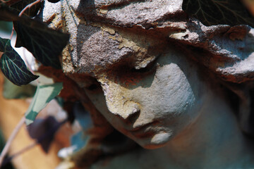 Sweet facial expression of beautiful sad angel. Vintage styled image of ancient statue.