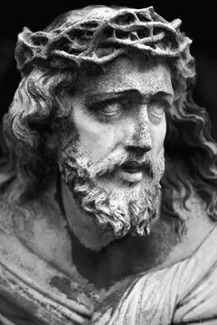 Fragment of an ancient marble statue of Jesus Christ. Pain, death, resurrection concept. Black and white vertical image.