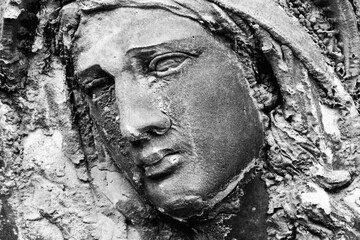 Black and white image of statue of Virgin Mary as a symbol of love and kindness.