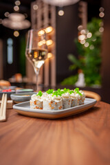 Sushi roll with cream cheese, sesame seeds and green flying fish caviar