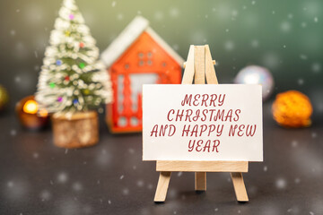 Easel with the words Happy New Year and Merry Christmas. New Year or Xmas winter holiday....