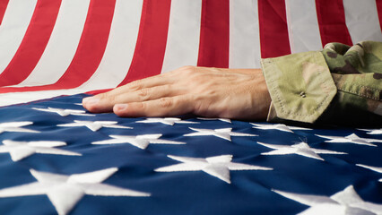 Hand caressing the stars and stripes of a USA flag 