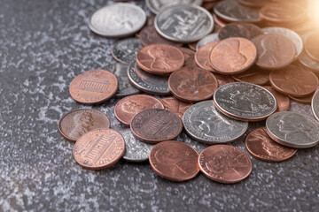 American coins and US dollars on a wooden table