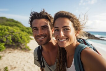 Portrait of a lovely young couple at sand beach. Summer tropical vacation concept.
