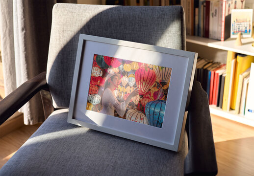 Mockup of customizable horizontal wooden picture frame on chair