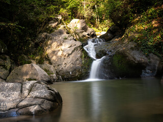 Beautiful waterfall in Covasna County framed by green moss and vegetation © Marian