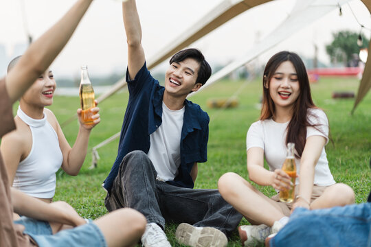 Image of group of friends celebrating and drinking beer together