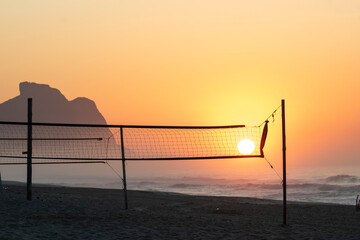 Recreio dos Bandeirantes beach at sunrise with the Pedra da Gavea mountain