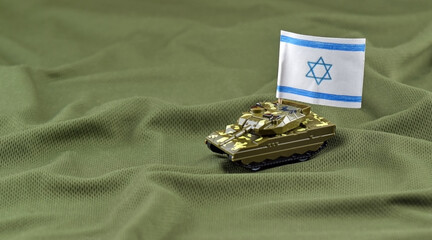 A battle tank with the Israeli flag on a background of US dollar banknotes.