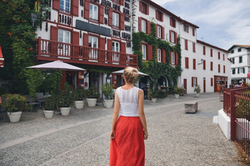 A woman near house with hanging peppers Espelette, France