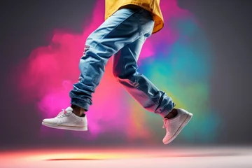 Deurstickers Hop dancer performing. Legs of a male hip hop dancer, cropped image of dancing person on colorful background. Modern hip hop dance banner template © Neda Asyasi