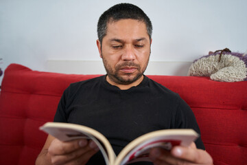 Man Contemplating with Book on Couch