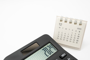 Calculator with the number 2024 on the display and Calendar DEC 2023. Concept of finance, taxes,...