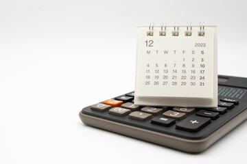 calculator and calendar DEC 2023 on white background for money and debt management concept....