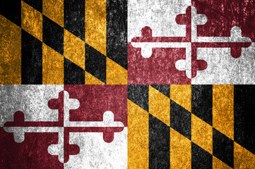 Close-up of the grunge Maryland state flag. Dirty Maryland state flag on a metal surface.