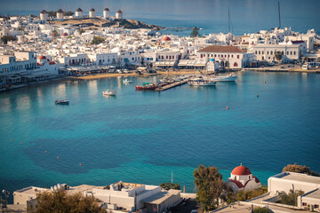 Obraz premium A stunning Mykonos vista: White houses against a breathtaking sea backdrop, a picture of Greek island paradise.
