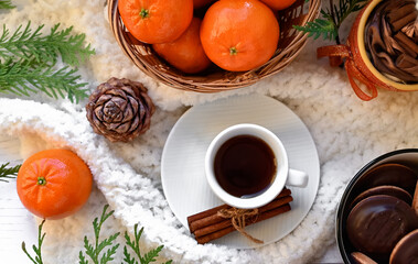 Still life with glasses of mulled wine or fruit tea, Red Poinsettia flowers, fir branch and spices on a dark background with copy space. New year and Christmas table setting. Greeting card.