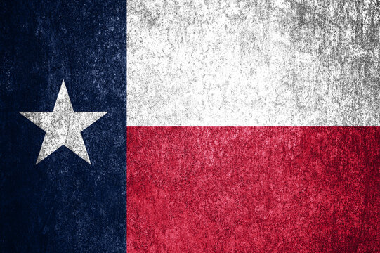 Close-up of the grunge Texas state flag. Dirty Texas state flag on a metal surface.